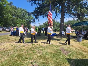 American Legion Post Color-Guard receives and raises the American flag.